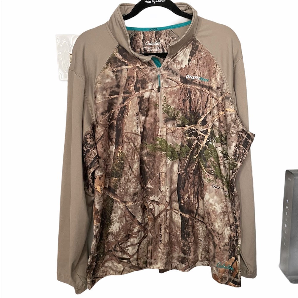 Cabela’s outfit her camouflage shirt.